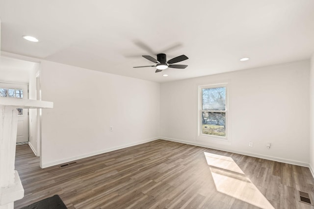 unfurnished room with dark hardwood / wood-style floors and ceiling fan