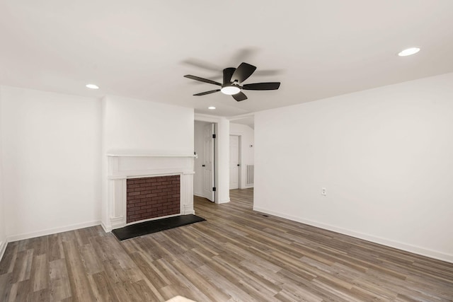 unfurnished living room featuring hardwood / wood-style flooring and ceiling fan