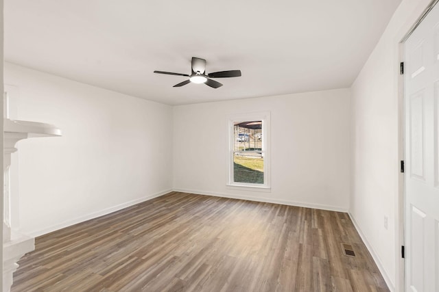 unfurnished room with hardwood / wood-style floors and ceiling fan