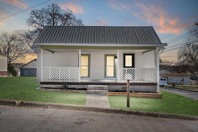 view of front of home with a yard and a porch