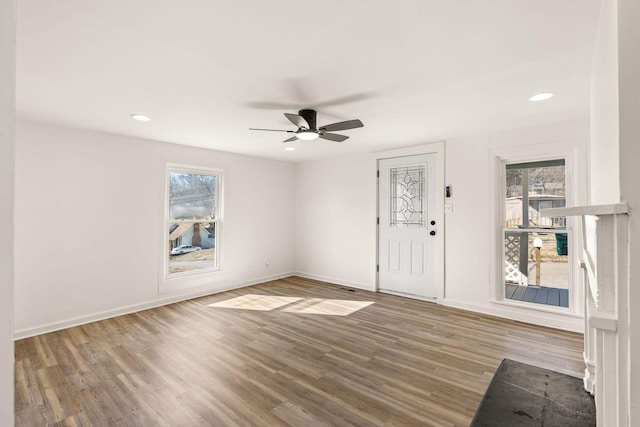 entryway featuring hardwood / wood-style flooring, a wealth of natural light, and ceiling fan