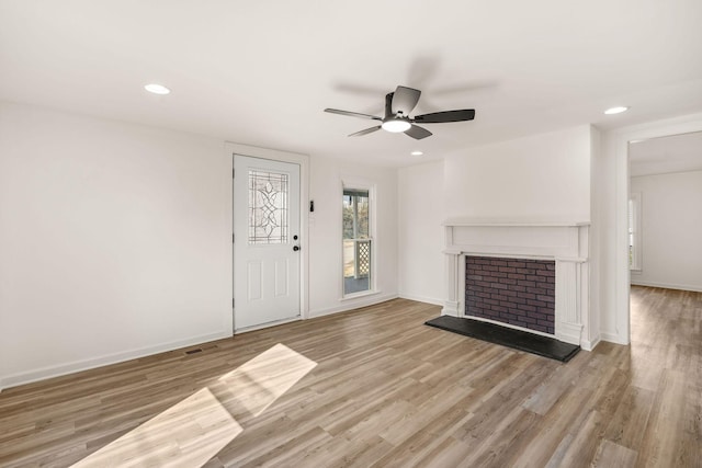 unfurnished living room with ceiling fan and light hardwood / wood-style flooring