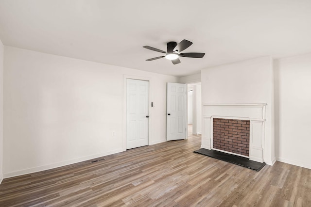 unfurnished living room featuring hardwood / wood-style flooring and ceiling fan