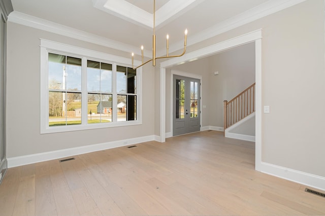 unfurnished dining area featuring a notable chandelier, crown molding, and light hardwood / wood-style floors