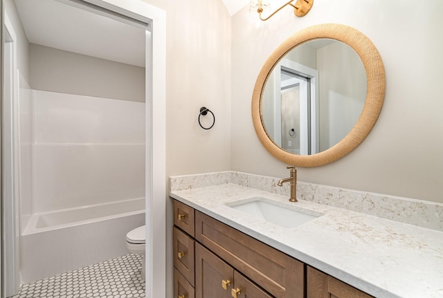 bathroom with vanity, a shower, and toilet