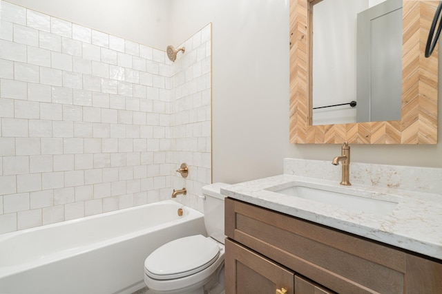 full bathroom with vanity, tiled shower / bath combo, and toilet