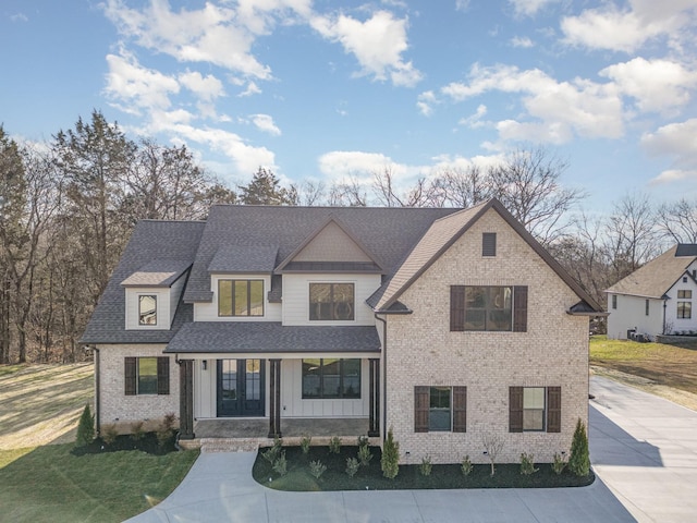 view of front of home with a porch and a front lawn