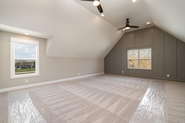 additional living space with light carpet, vaulted ceiling, and ceiling fan