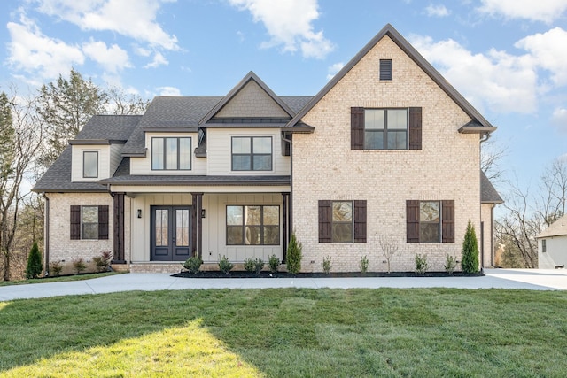 view of front facade featuring french doors and a front lawn