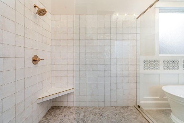 bathroom with separate shower and tub, tile patterned flooring, and tile walls