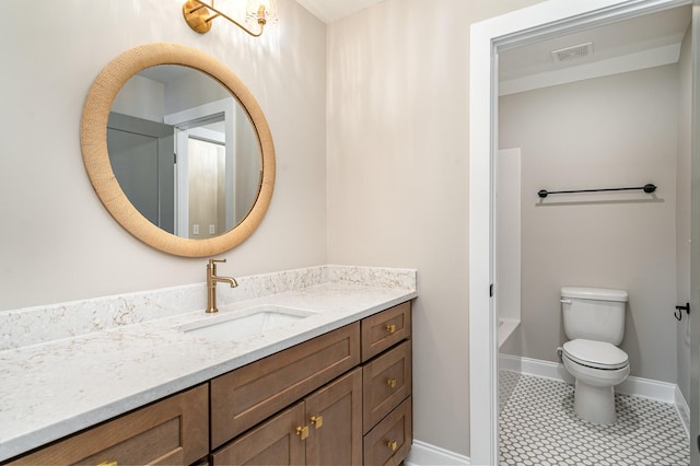 bathroom featuring vanity, tile patterned floors, and toilet