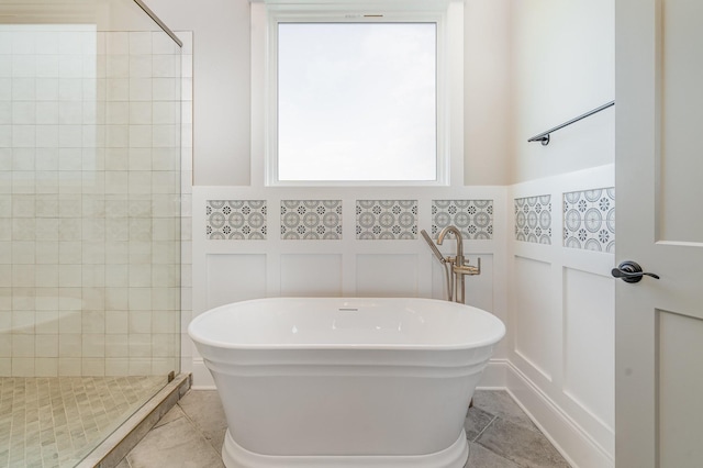 bathroom featuring separate shower and tub