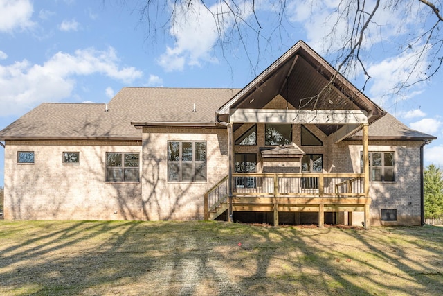 rear view of property with a yard and a deck