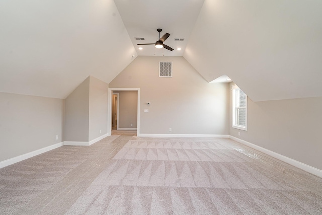 additional living space with ceiling fan, light colored carpet, and lofted ceiling