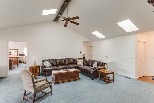 living room featuring beamed ceiling, ceiling fan, visible vents, and carpet floors