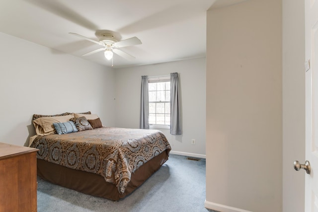 carpeted bedroom with visible vents, a ceiling fan, and baseboards