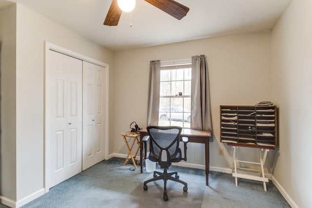 carpeted home office featuring baseboards and ceiling fan