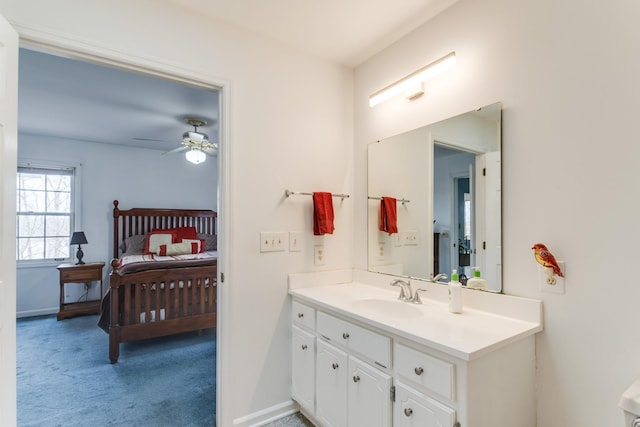 bathroom featuring vanity, a ceiling fan, baseboards, and connected bathroom