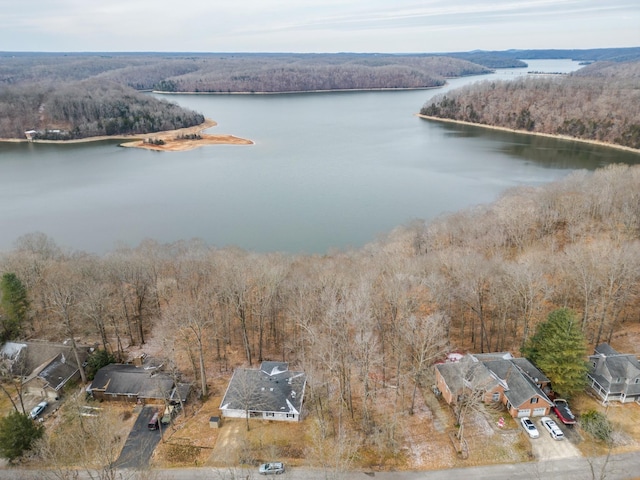 aerial view featuring a forest view and a water view