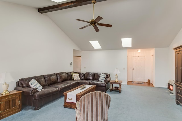 carpeted living area with beam ceiling, a skylight, a ceiling fan, and high vaulted ceiling