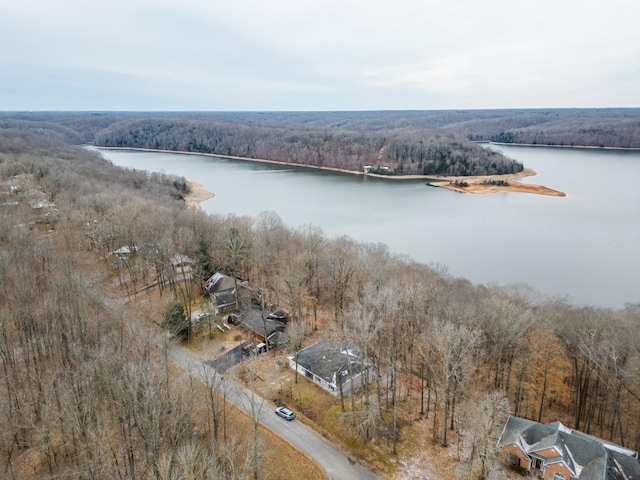 drone / aerial view with a forest view and a water view