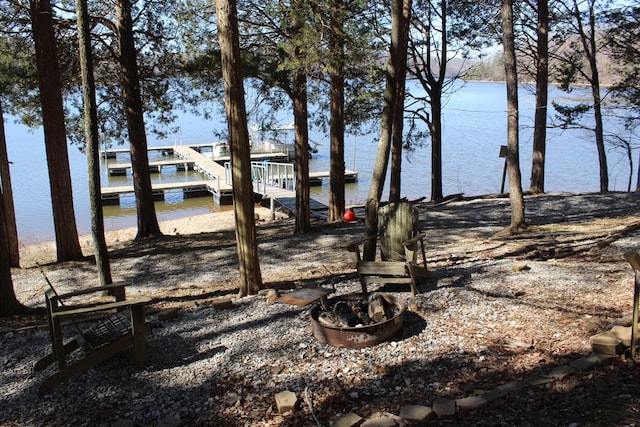 view of yard featuring a water view and a boat dock