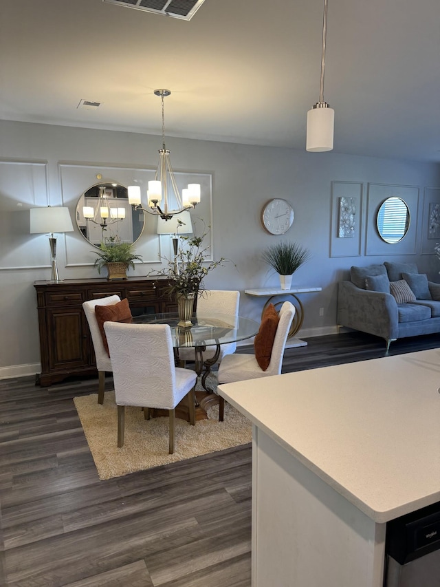 dining area featuring dark hardwood / wood-style flooring and a chandelier