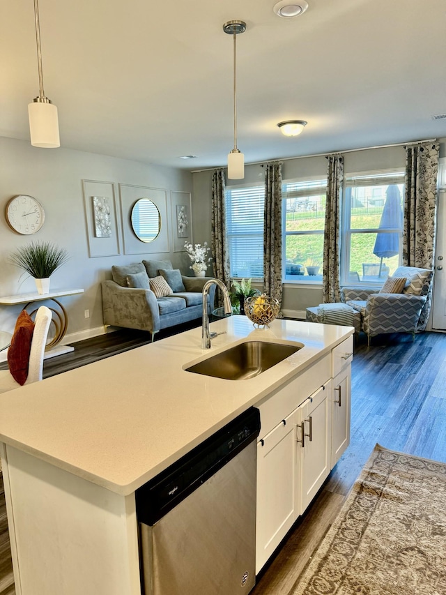 kitchen with sink, white cabinetry, decorative light fixtures, dishwasher, and an island with sink