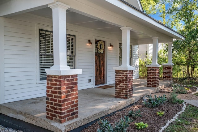 view of exterior entry with a porch