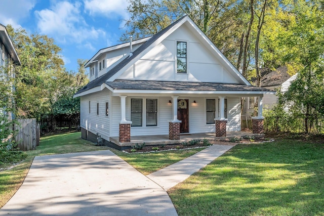 view of front facade featuring a front lawn and covered porch