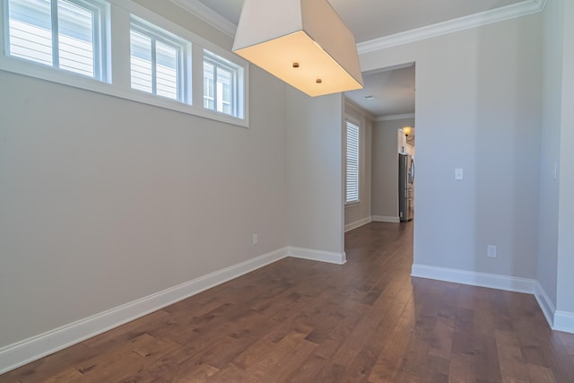 unfurnished room featuring crown molding and dark wood-type flooring