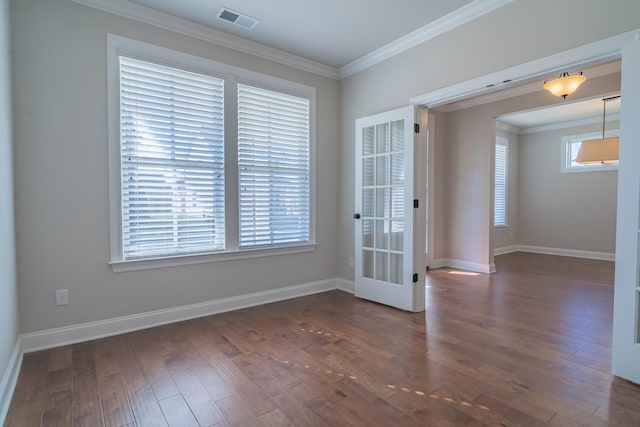 empty room with ornamental molding and dark wood-type flooring