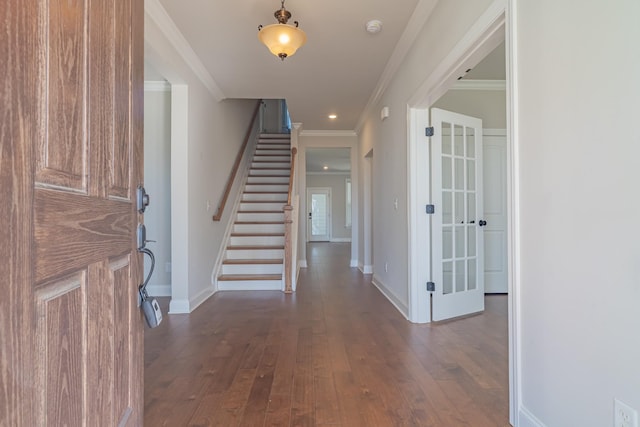 entryway featuring dark wood-type flooring and ornamental molding