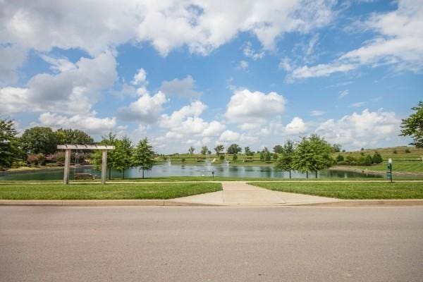 surrounding community featuring a water view and a yard