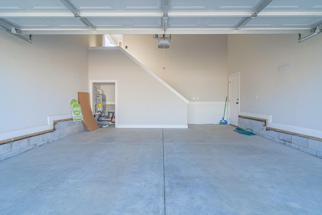 garage with a garage door opener and water heater