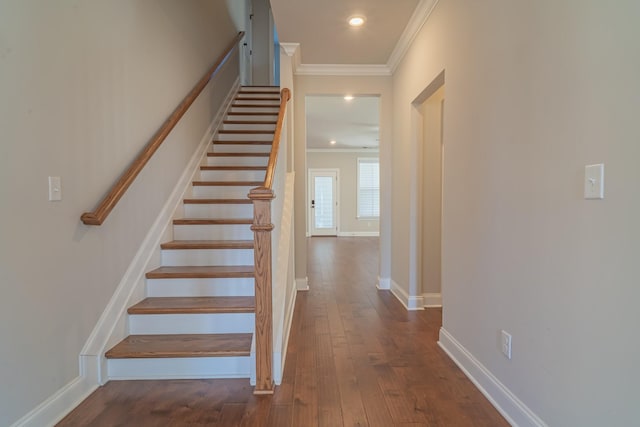 stairway with hardwood / wood-style floors and ornamental molding