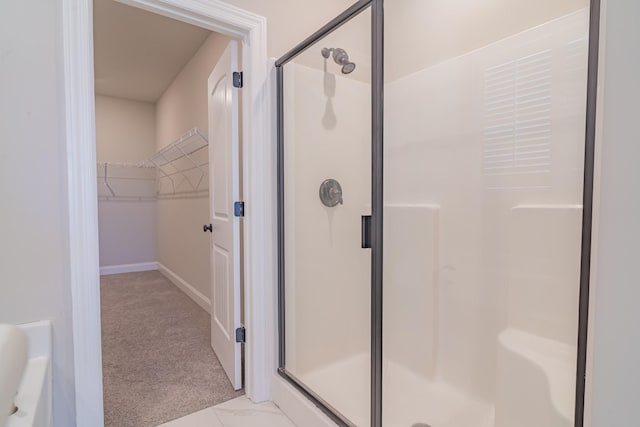 bathroom with a shower with shower door