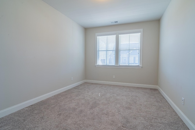 spare room with light colored carpet