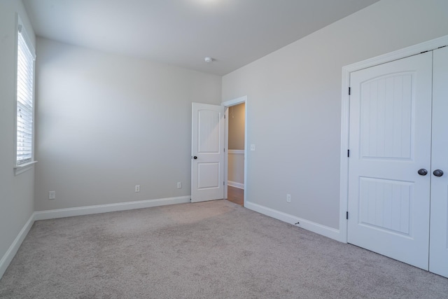 carpeted empty room featuring a wealth of natural light