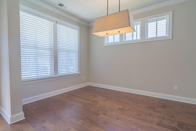 empty room with dark wood-type flooring and ornamental molding