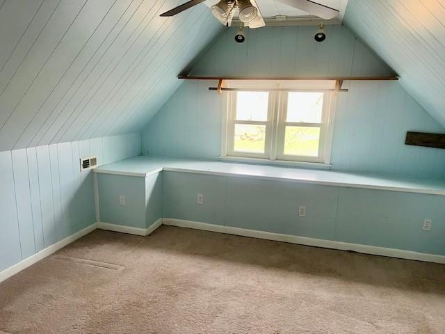 bonus room with ceiling fan, light colored carpet, and vaulted ceiling