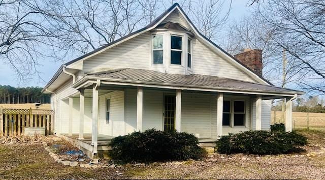 view of side of property with covered porch