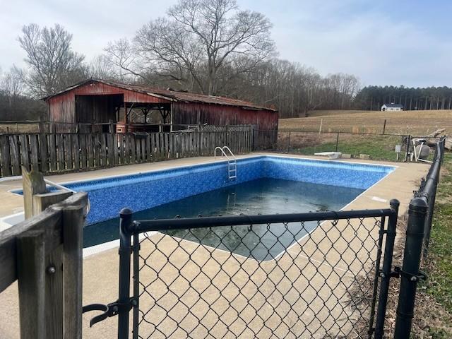 view of pool featuring a diving board