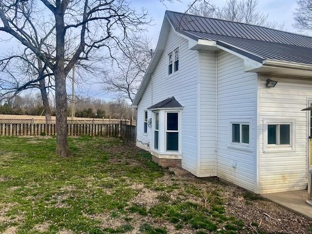 view of side of home featuring a yard