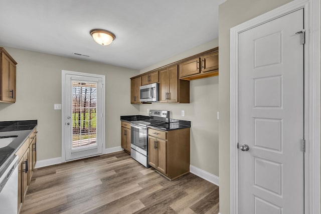 kitchen featuring appliances with stainless steel finishes and light wood-type flooring