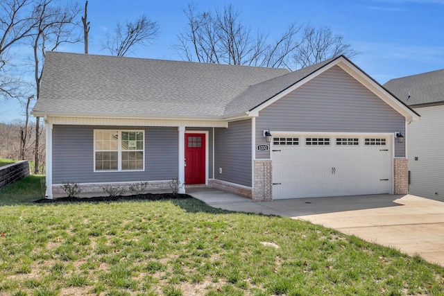 view of front facade with a front yard, concrete driveway, roof with shingles, and an attached garage