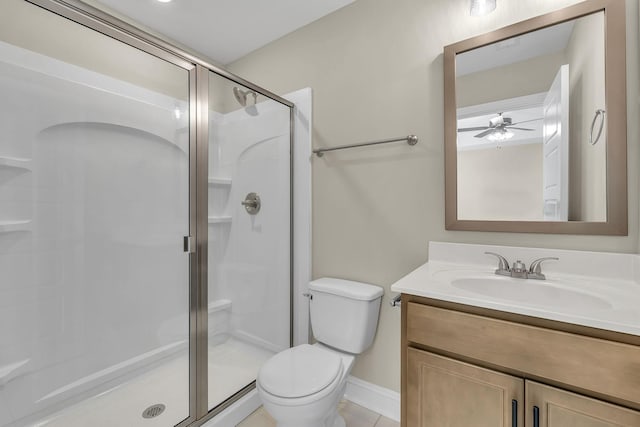 bathroom with tile patterned floors, vanity, toilet, and a shower with shower door