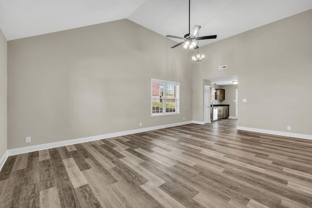 unfurnished living room with light hardwood / wood-style flooring, high vaulted ceiling, and ceiling fan