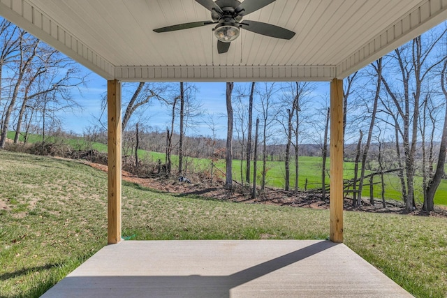 view of patio featuring ceiling fan and a rural view