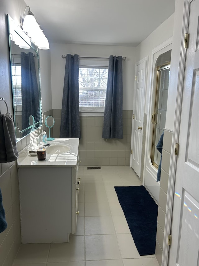 bathroom featuring tile walls, vanity, and tile patterned flooring